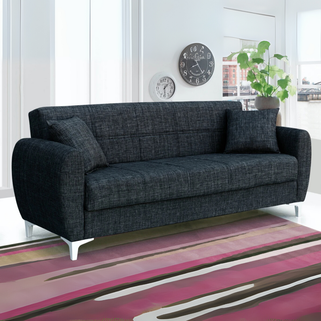 A modern black 3 seater sofa bed with contemporary curved armrests and metal legs, set in a stylish living room.