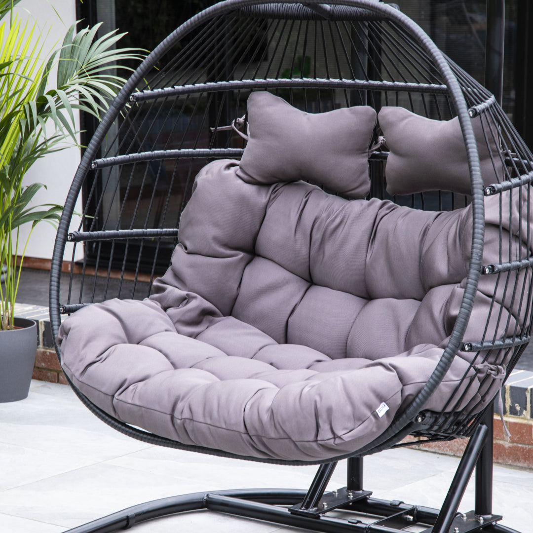 Close-up of the plush grey cushion and durable black rattan weave of the 2-seater egg chair.