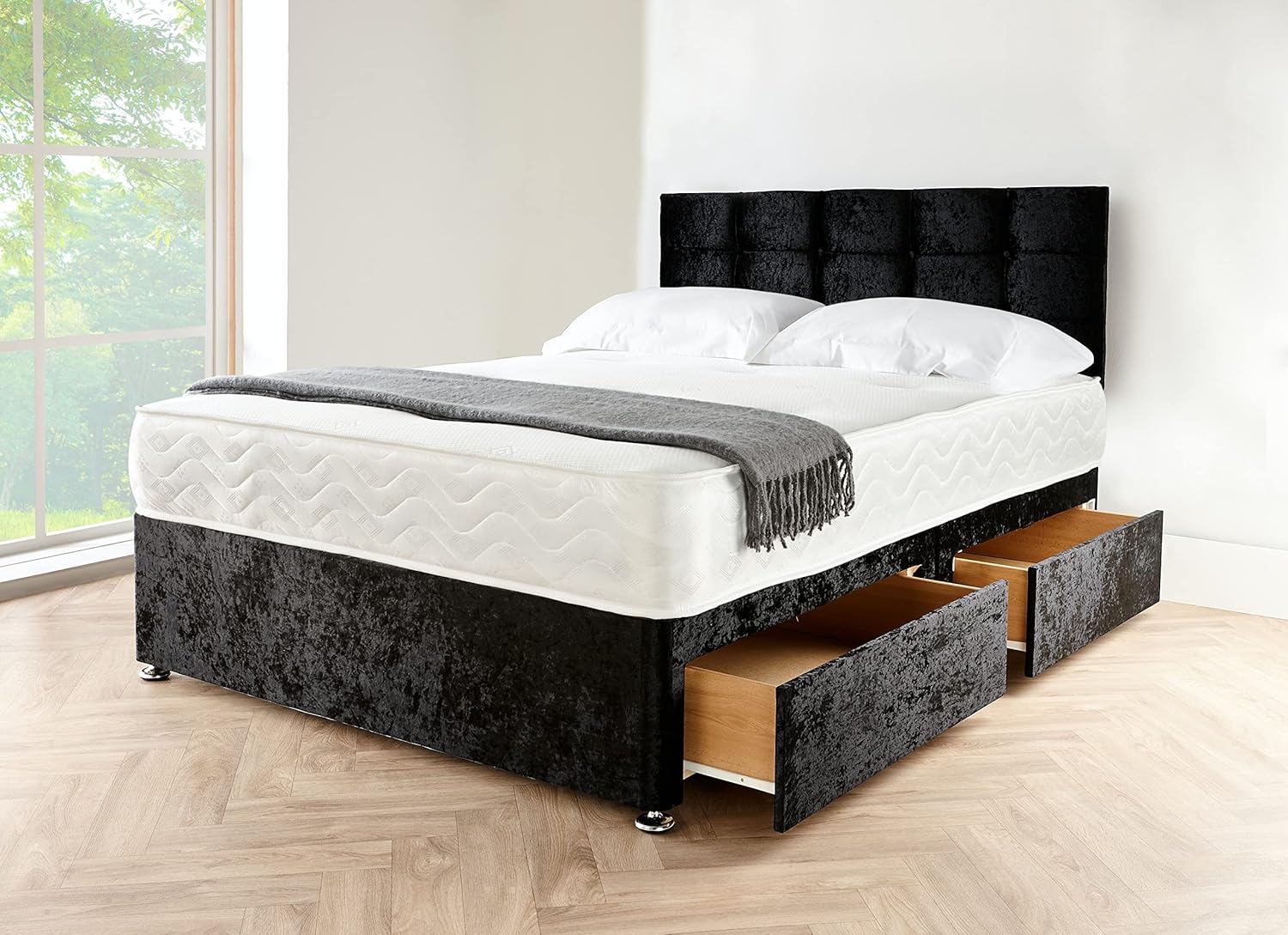 A sleek black divan bed set with a matching upholstered headboard and two under-bed storage drawers.