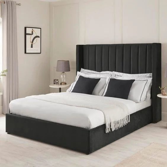 High-quality black Plush Velvet Ottoman Bed Frame, featuring a deep upholstered headboard and hydraulic gas lift storage, Handmade in the UK.