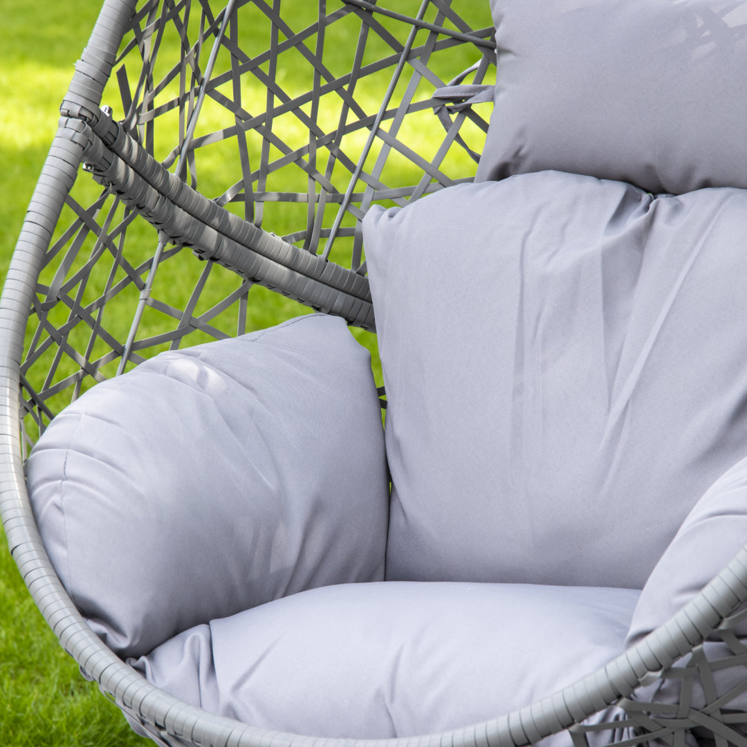 Elegant shot of the grey single hanging egg chair with cushion on a modern balcony.